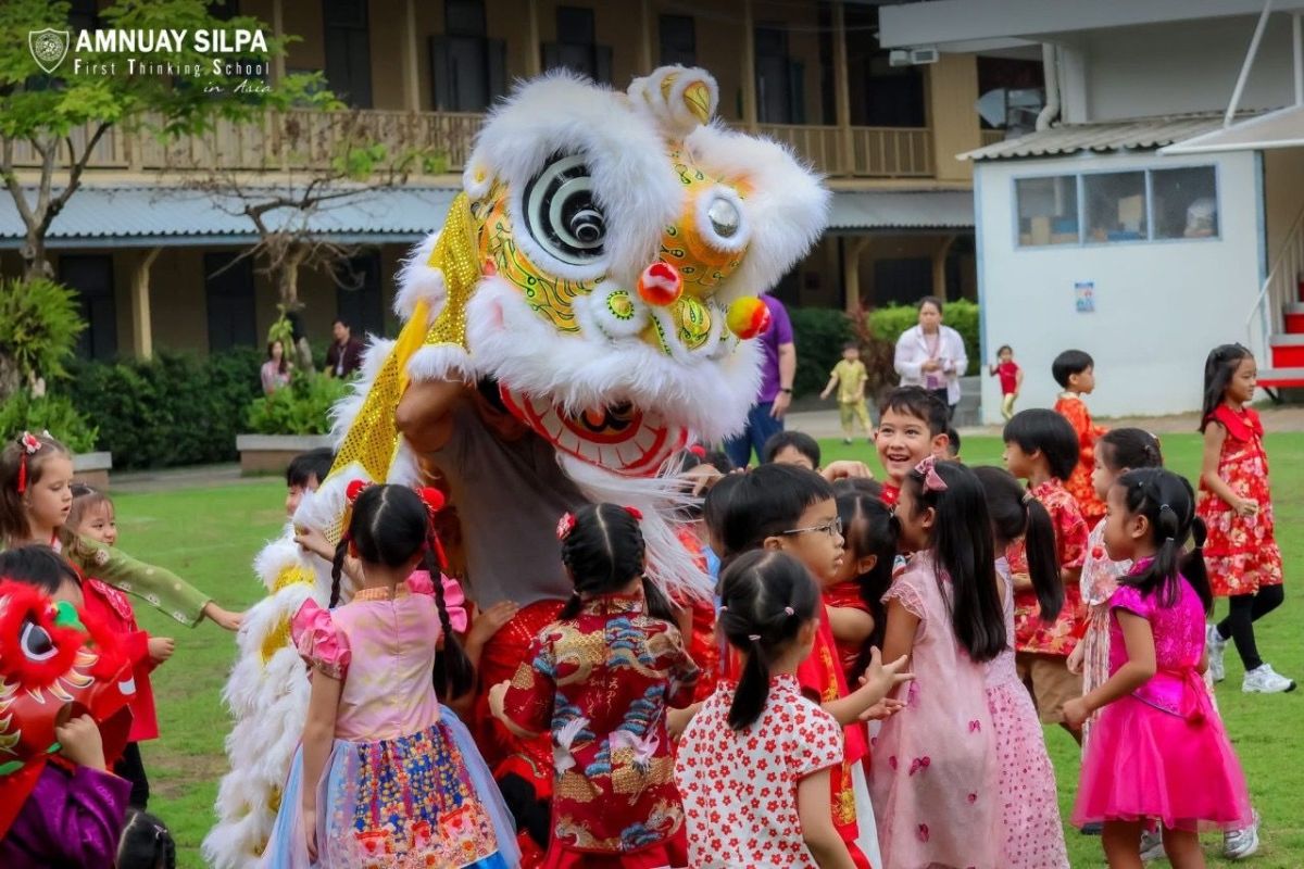 Children in primary years playing on campus at Amnuay Silpa School during break time