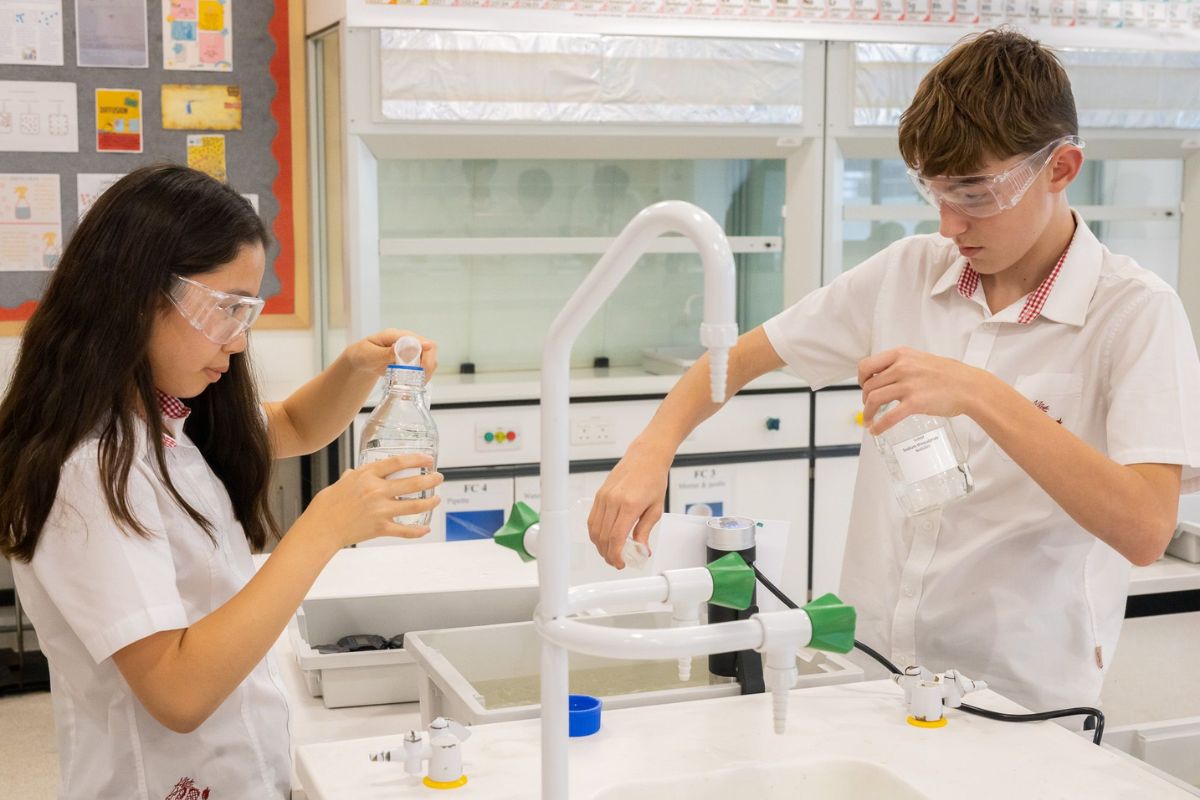Secondary school students conducting science experiments in a modern laboratory environment
