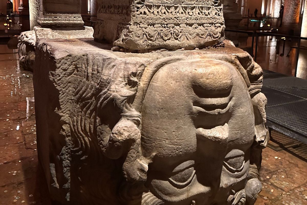 A striking underground view of the Basilica Cistern, featuring ancient columns rising from still water beneath Istanbul.