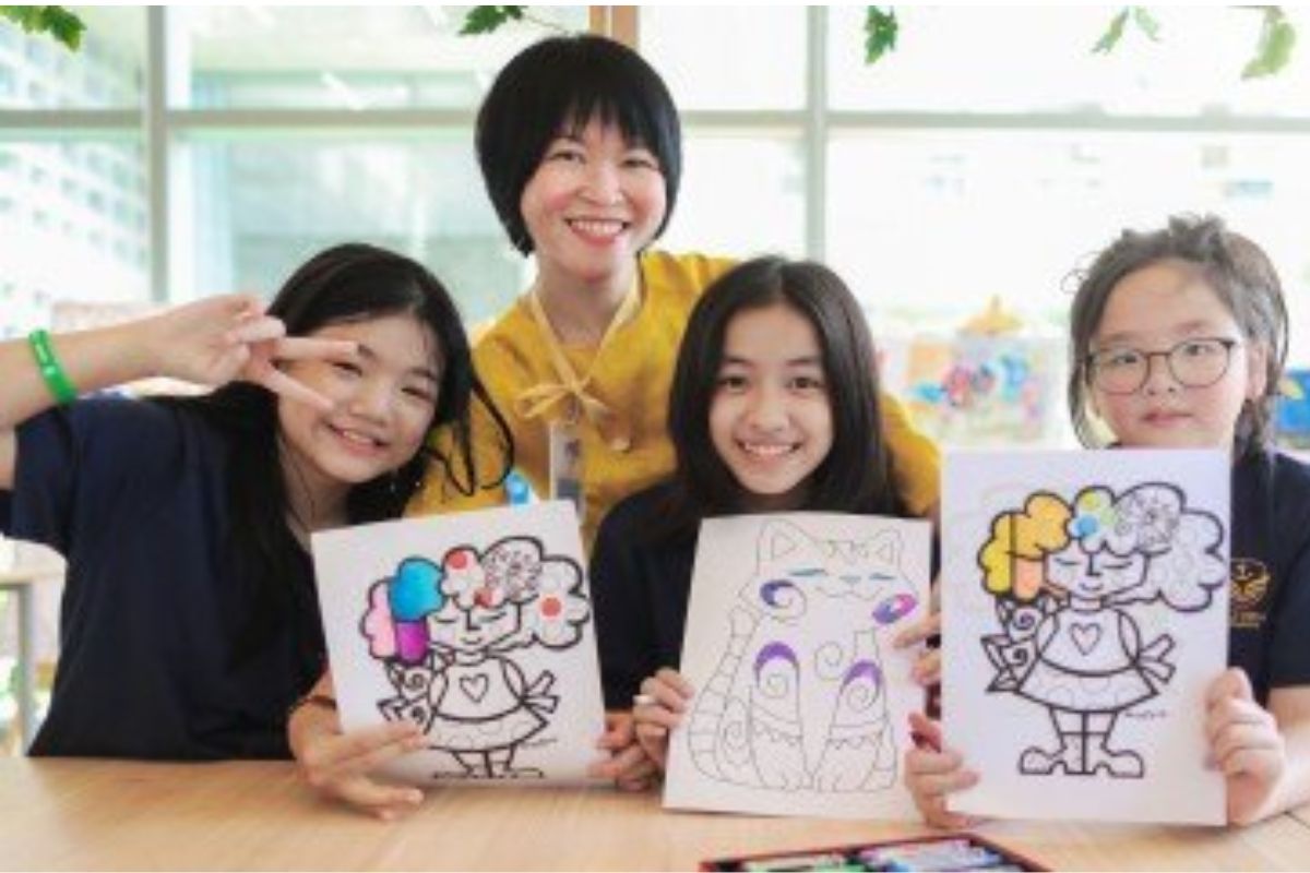School children working together in a classroom during group learning activity with teacher support 