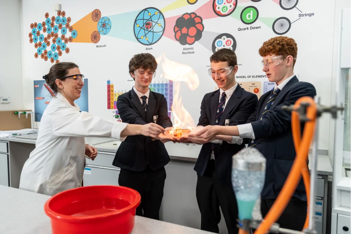 Student and teacher conducting a science experiment together in a modern school laboratory