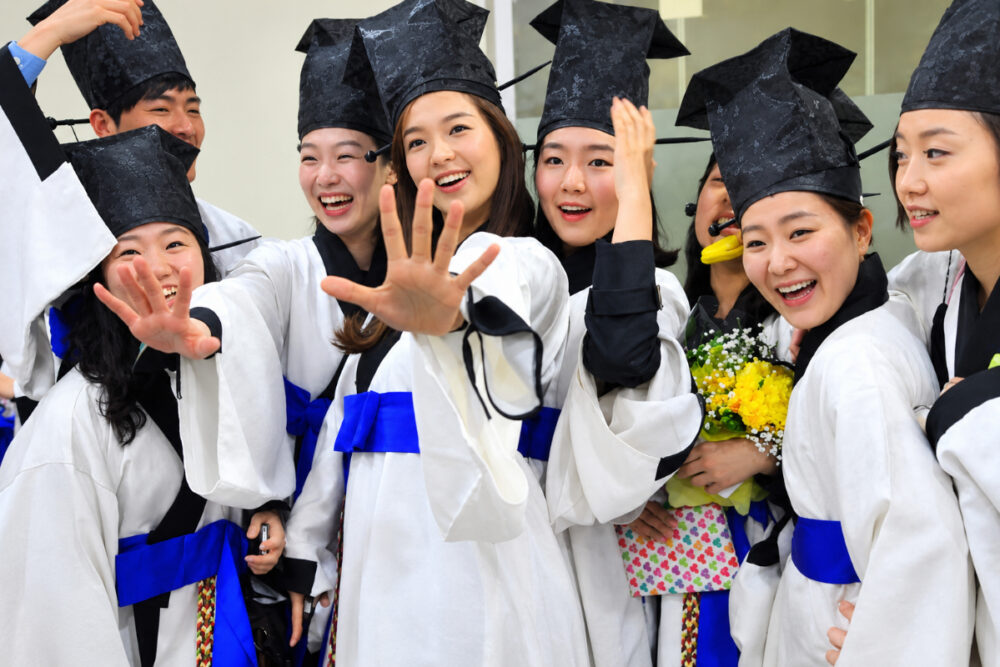 South Korean classical music college students wearing traditional scholar outfits pose for a photo during a graduation ceremony at a university in Seoul on February 17, 2011. PHOTO: AFP