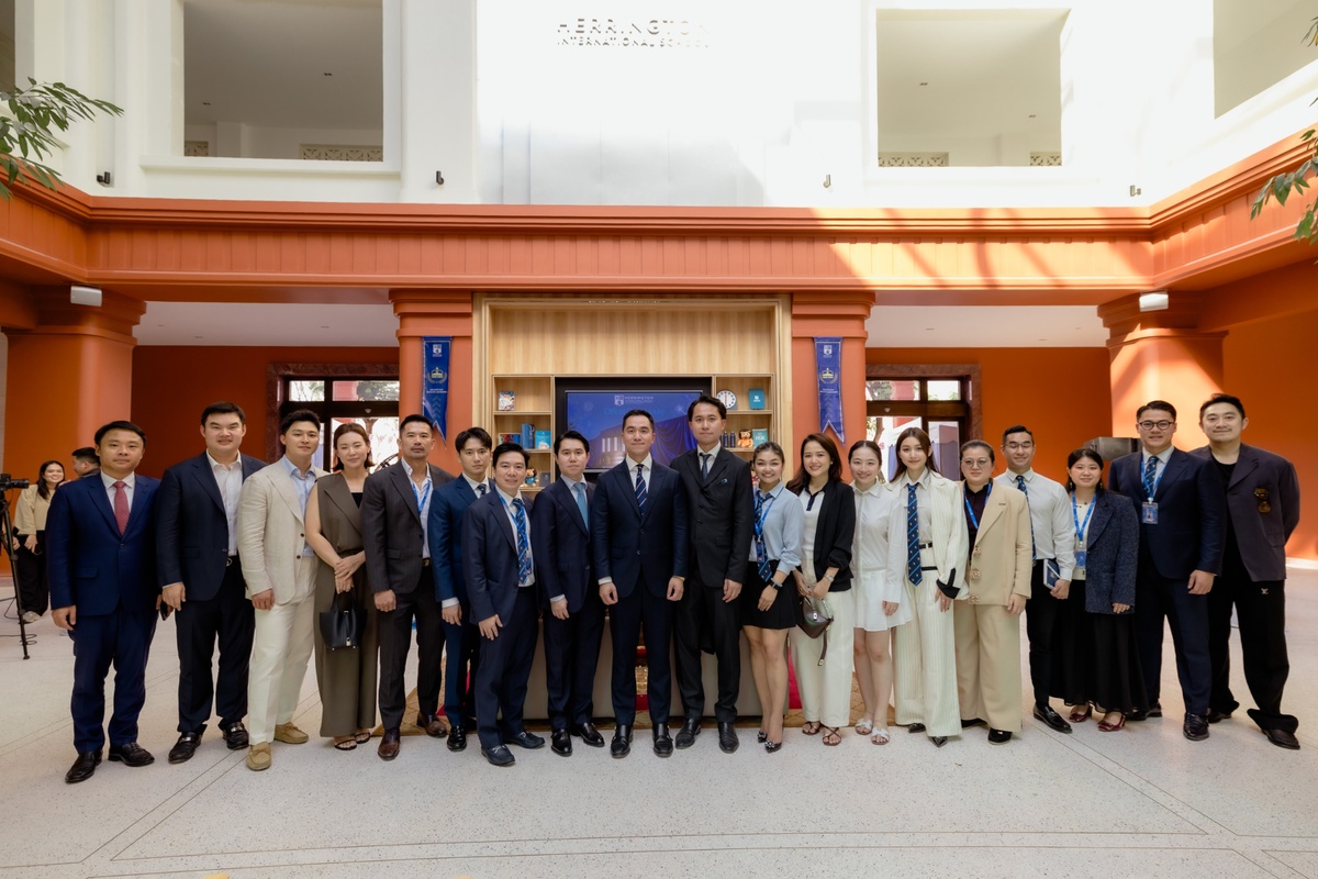 Herrington International School representatives pose for a group photograph inside the school's new campus in Cambodia. Image via Cambodianess.