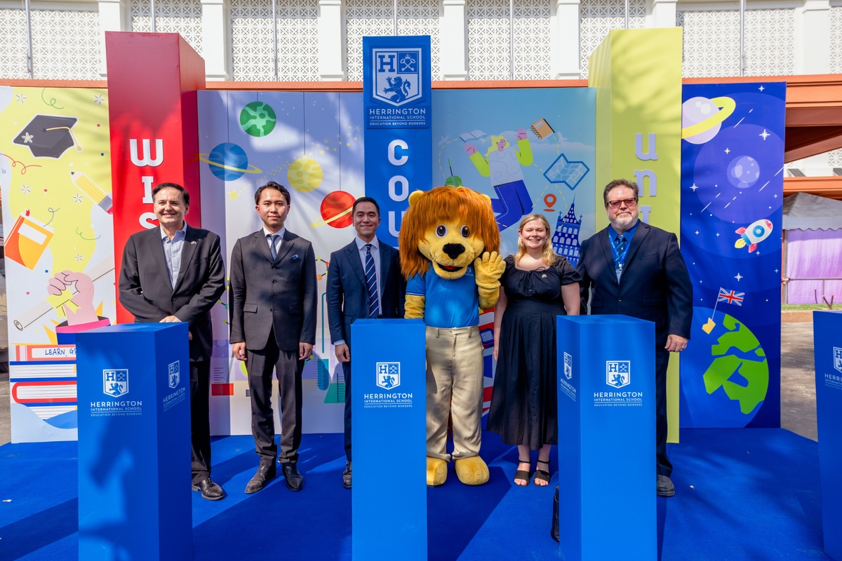 Herrington International School representatives pose with the school mascot at the campus grand opening in Cambodia. Image via Camodianess.